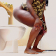 A black girl farts and shits while sitting on a toilet. Farting and plopping sounds are loud and clearly heard. No face or poop is visible. Presented in 720P HD. About 2.5 minutes.